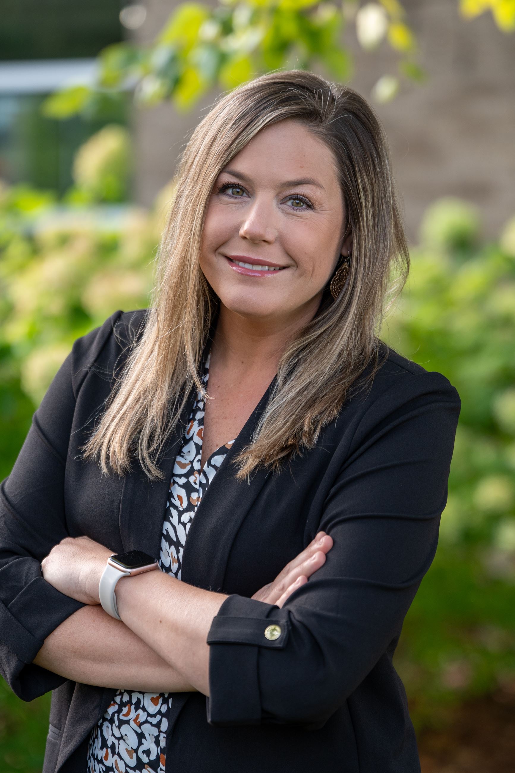 woman with arms crossed wearing a black jacket