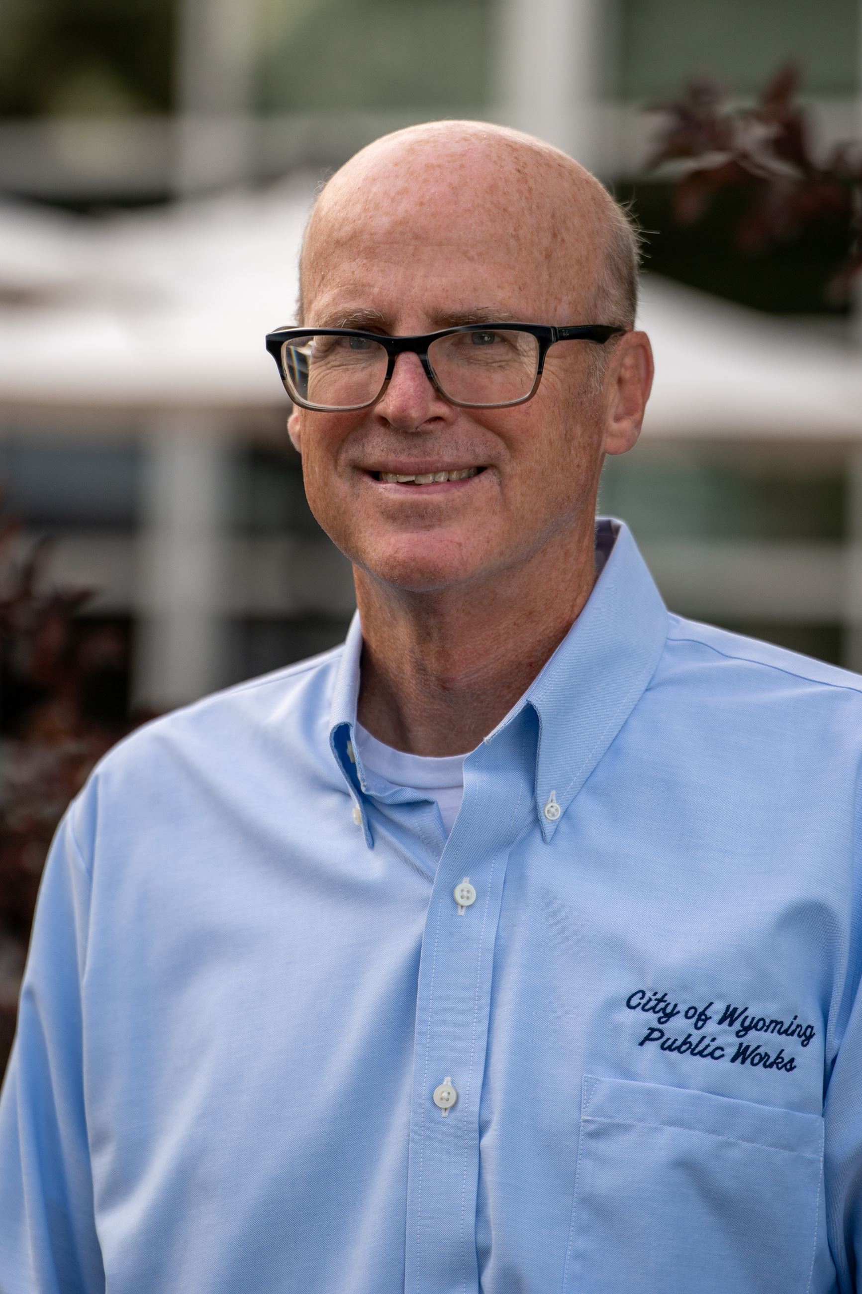 man wearing glasses with a blue button down shirt